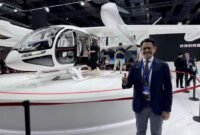 Denon Prawiraatmadja, CEO sekaligus pendiri Whitesky Group, perusahaan operator helikopter dari Indonesia, berfoto bersama sebuah pesawat eVTOL VE25-100 dalam ajang INTERNATIONAL ADVANCED AIR MOBILITY EXPO 2026 di Shanghai, China timur. [Xin]