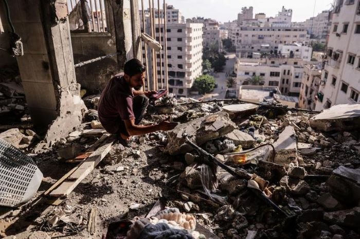 Warga Palestina memeriksa reruntuhan setelah serangan udara Israel menghantam sebuah apartemen di Gaza City pada 2 Agustus 2026. [Xin]