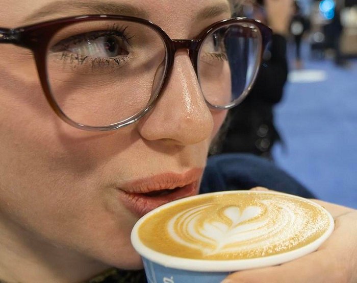 Seorang wanita minum secangkir kopi dengan hiasan latte di atasnya dalam ajang Restaurants Canada Show (RC Show) 2026 di Mississauga, Ontario, Kanada, pada 8 Maret 2026. (Xinhua)