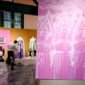 Petugas membersihkan sebuah arca yang dipajang menjelang pembukaan pameran